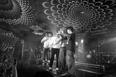 The Kabins band take a bow on stage under a patterned canopy at th Beautiful Days Festival